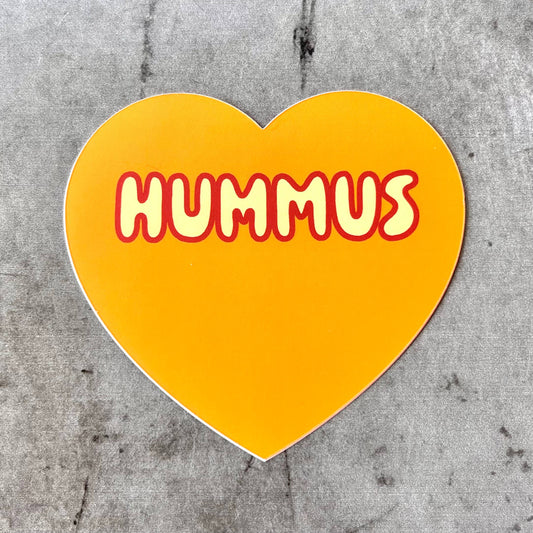 Dark orange, heart-shaped sticker with "Hummus" printed in light orange bubble letter font.