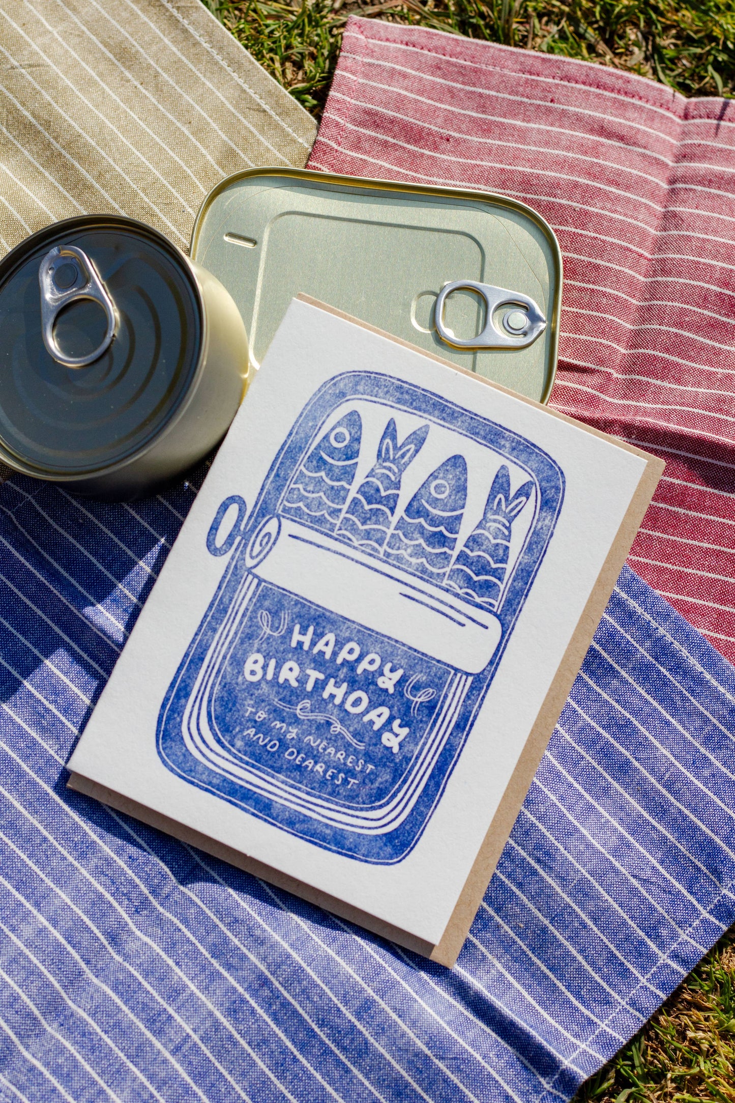 Birthday greeting card with an opened sardine tin on it. Text on bottom of tin reads "Happy Birthday to my nearest and dearest"