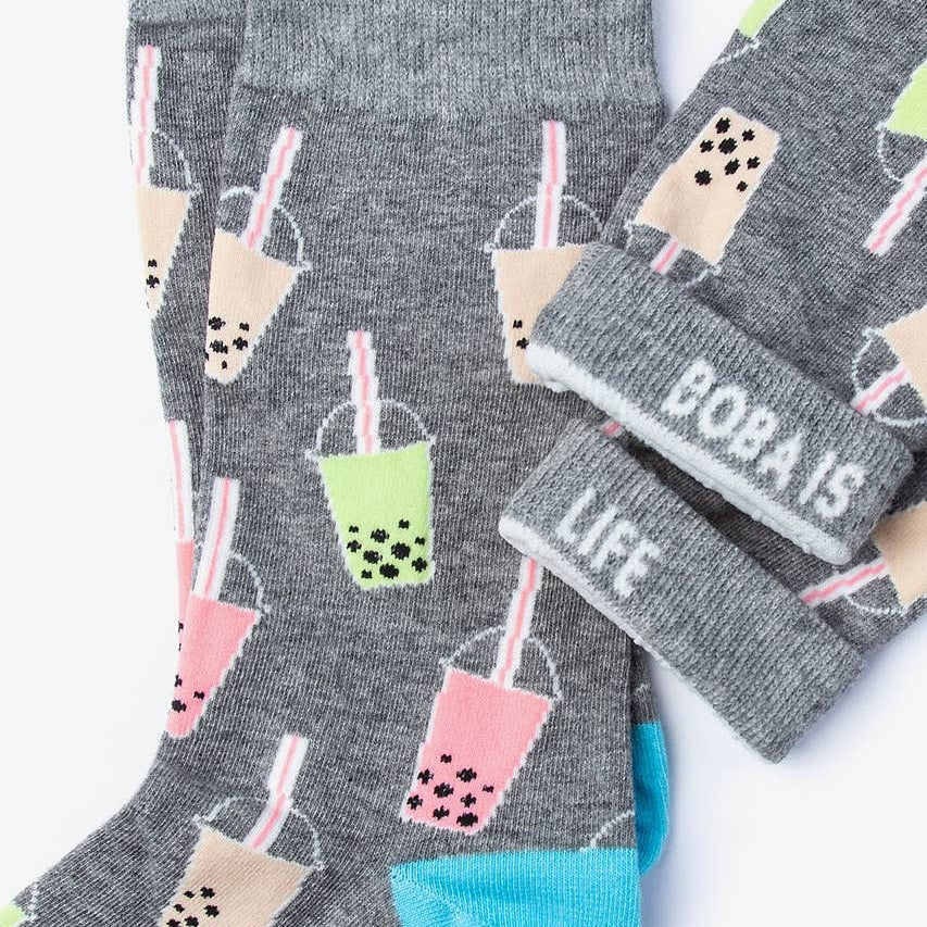 Gray socks with bubble tea design and 'BOBA IS LIFE' text on a white background