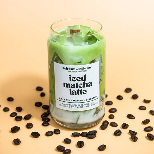 Candle labeled 'Iced Matcha Latte' with coffee beans on a beige background