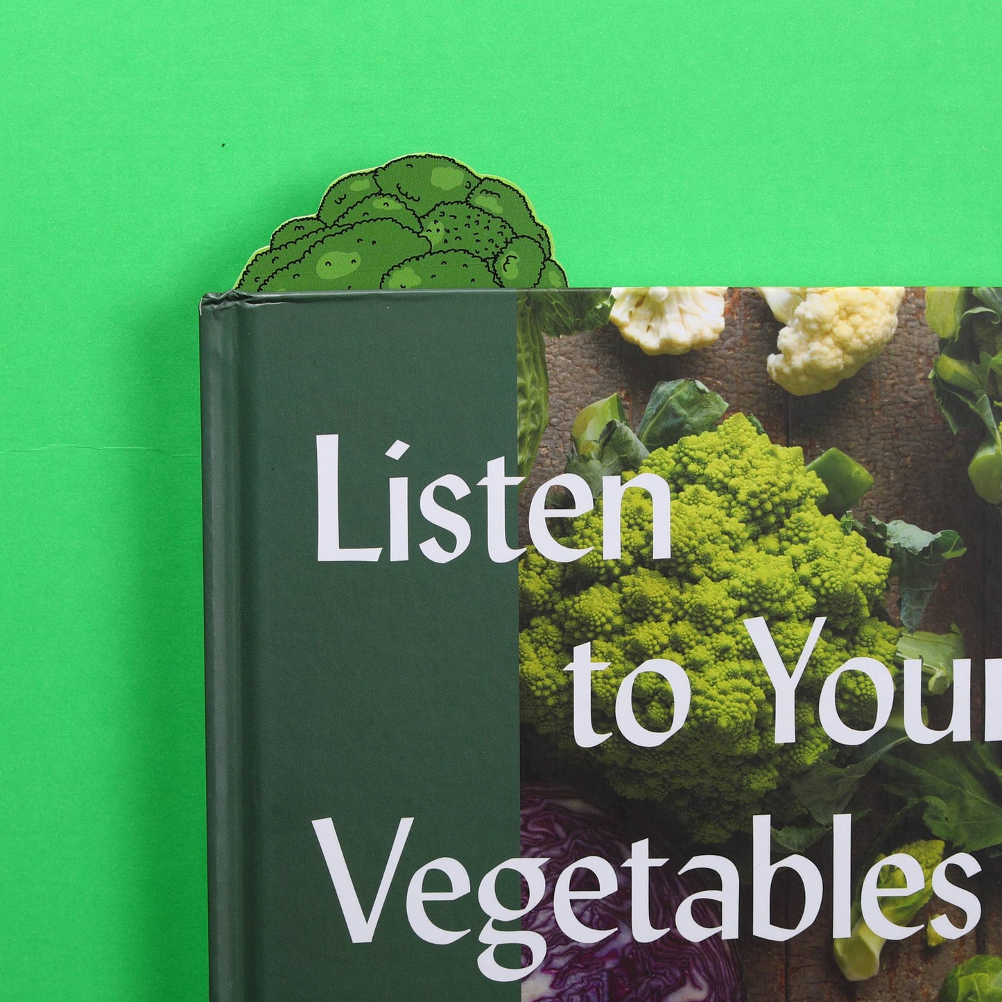 Broccoli bookmark peeking out from a book 