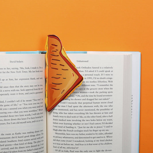 bookmark that looks like a triangle shaped half of a grilled cheese sandwich inside a book 