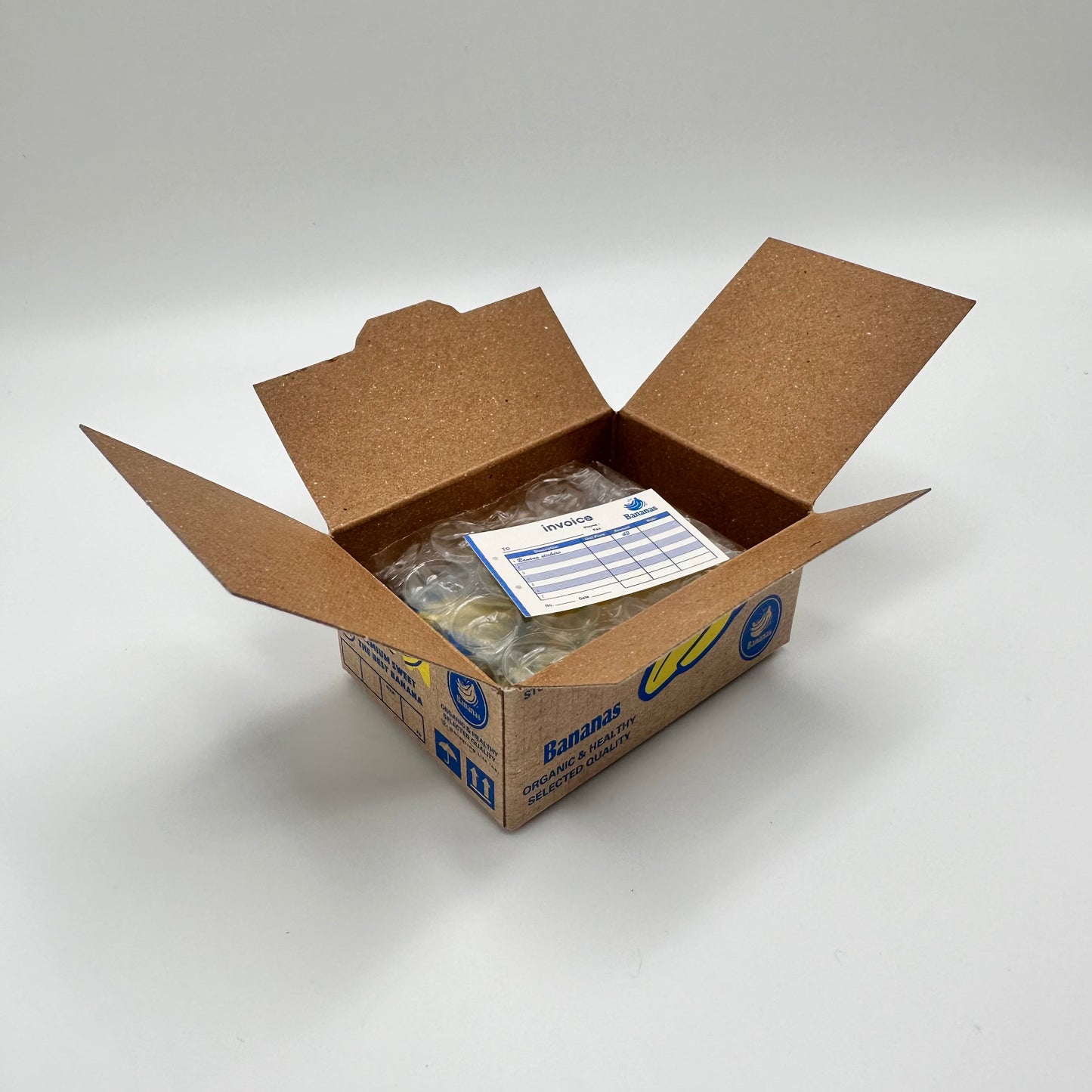 Banana sticker box that is open to reveal a tiny sticker invoice.