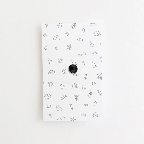 Back side of cardstock showing rubber pin cover.