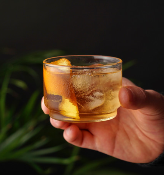 Single Bodega stackable glass with a cocktail in it