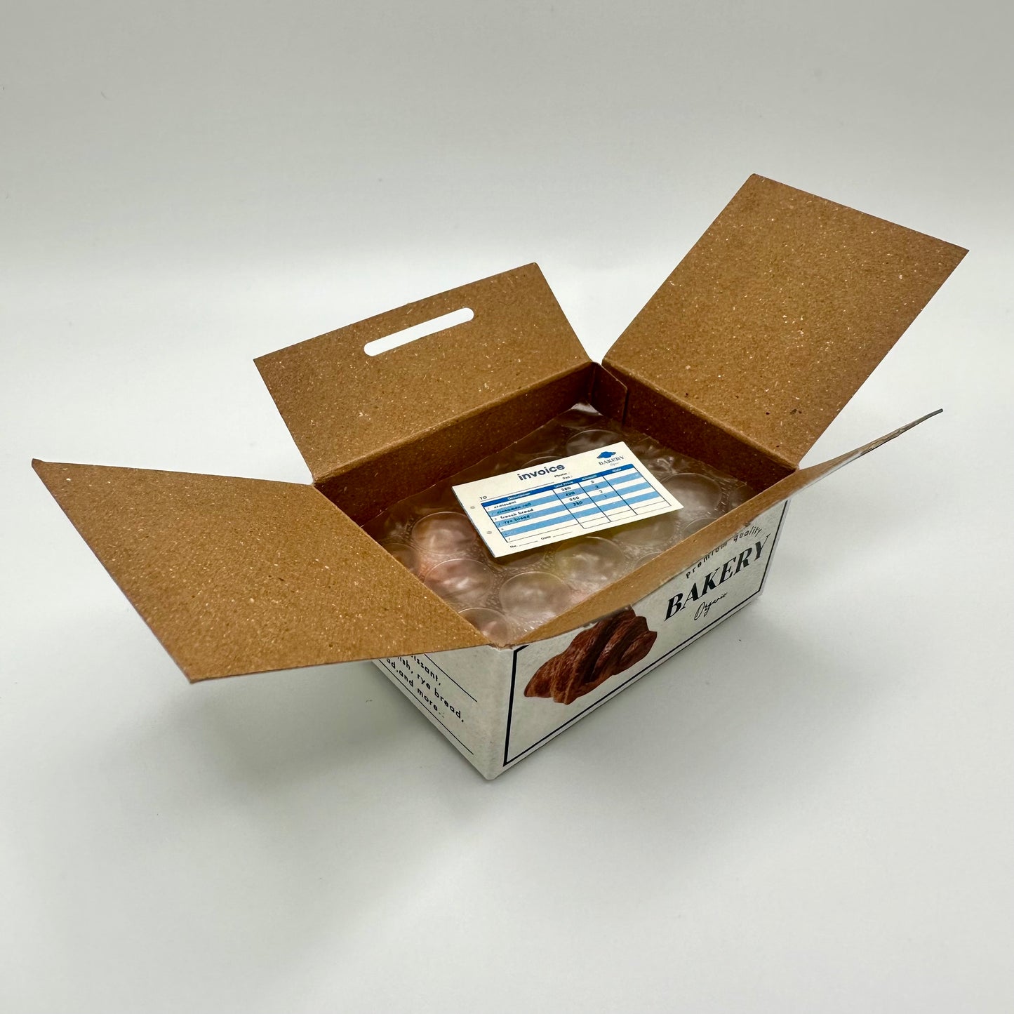 Mini bakery sticker box that is open to reveal a little invoice sticker
