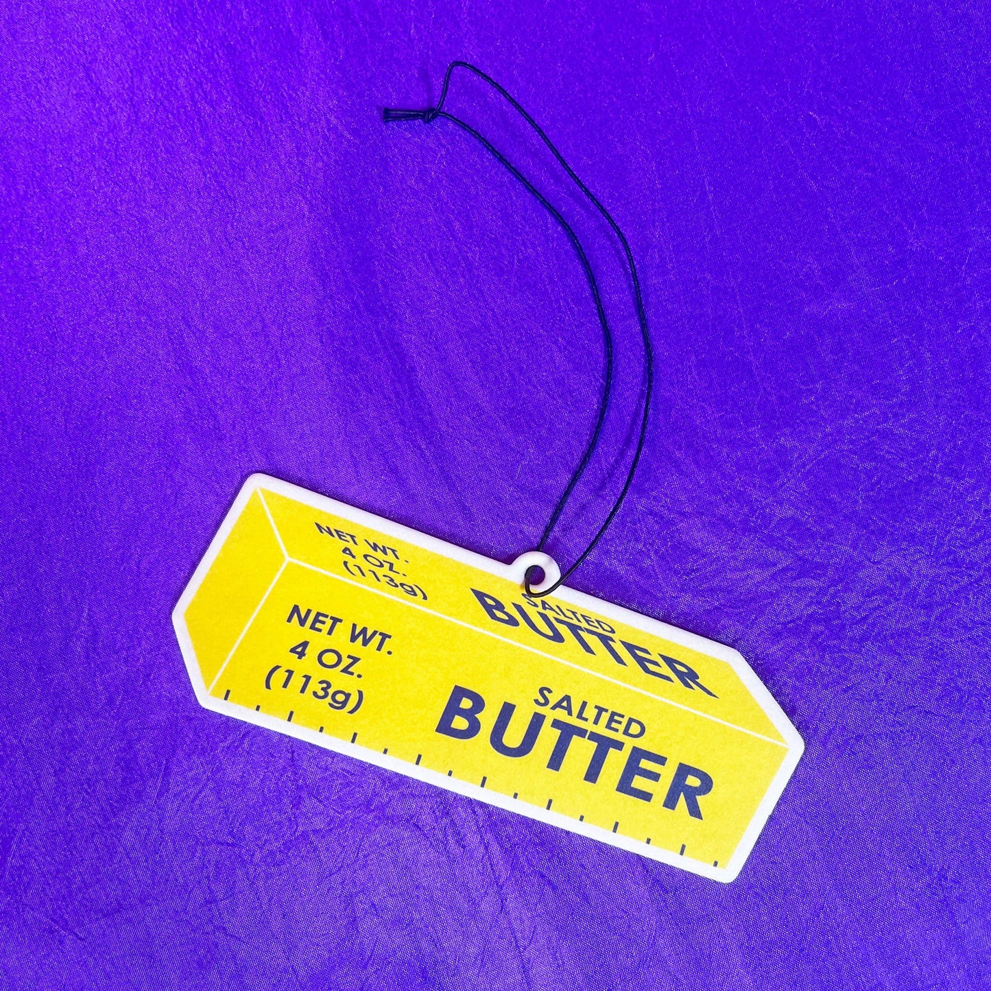Air freshener made to look like a stick of butter. Includes string for hanging