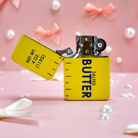 Lighter that looks like a stick of butter. It is open to show how it flips open.