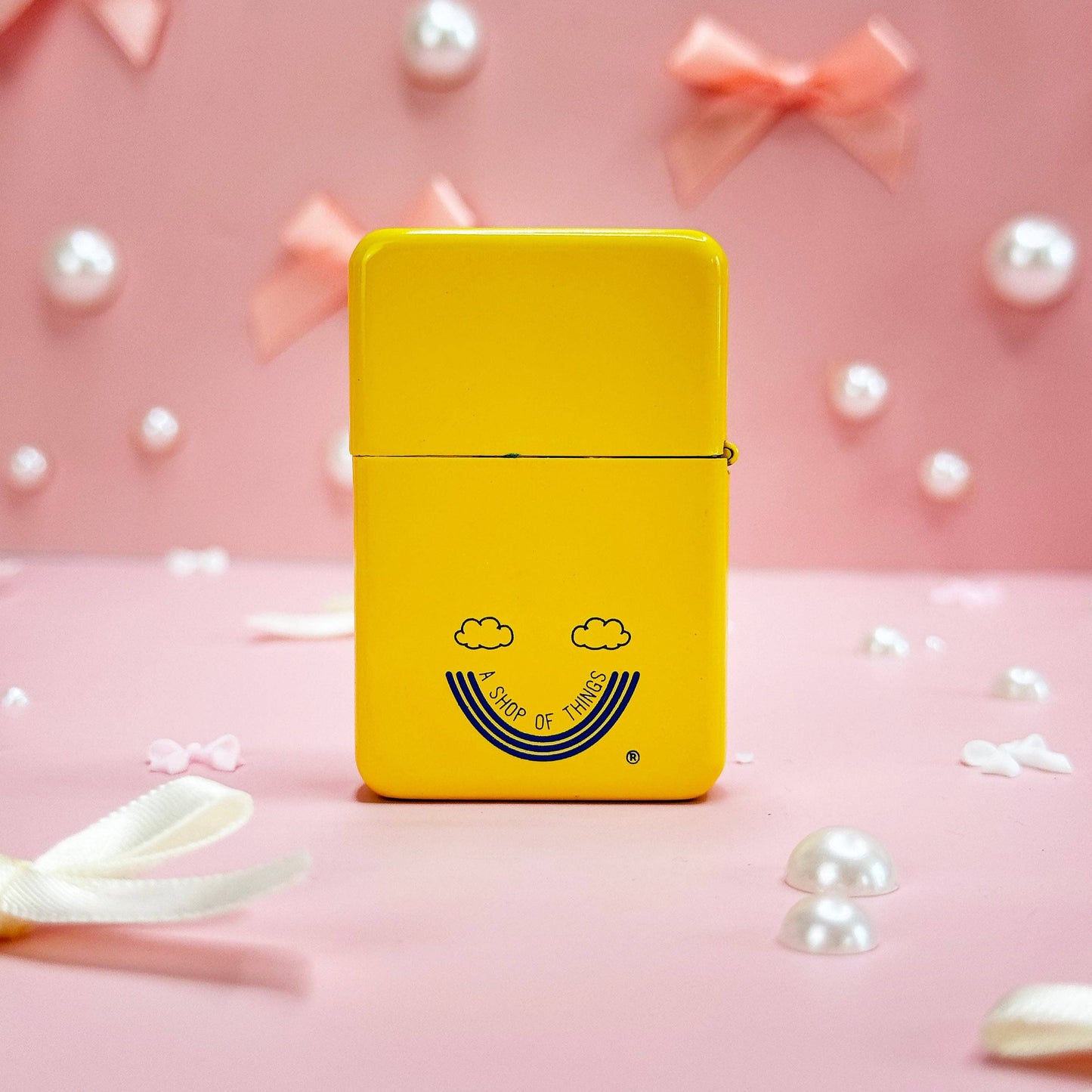 Back side of the butter lighter showing the logo for "A shop of things" brand.