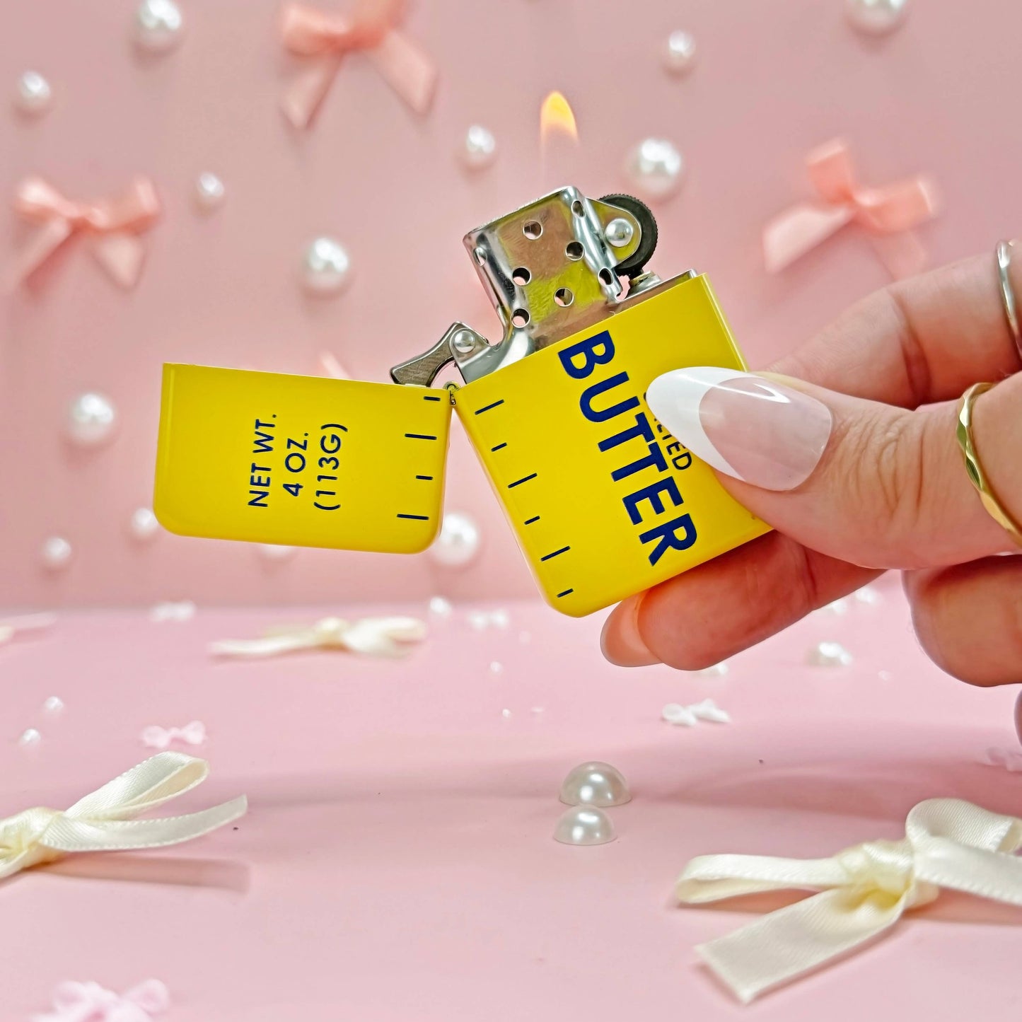 Butter lighter with a hand holding the lighter.
