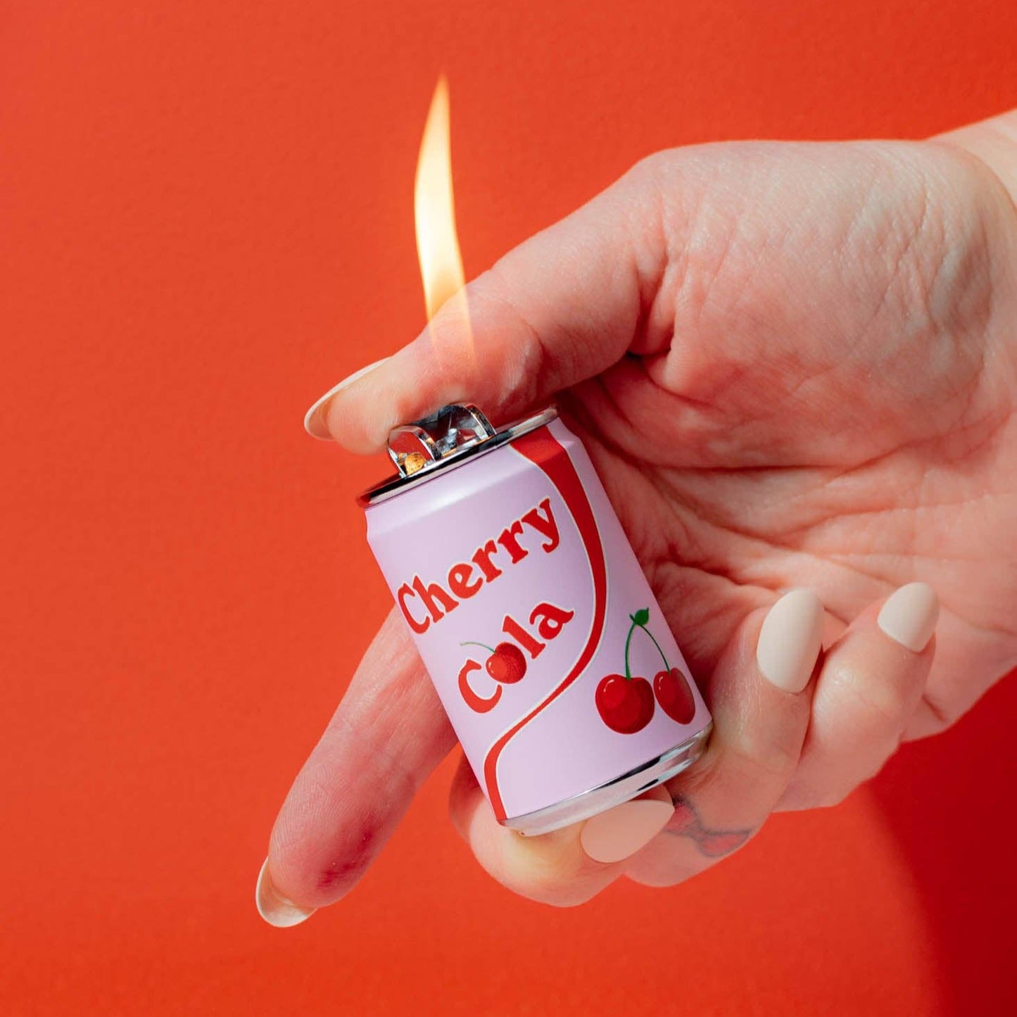 Refillable lighter shaped like a "Cherry Cola" soda can - white with red stripe and pair of cherries on the side.