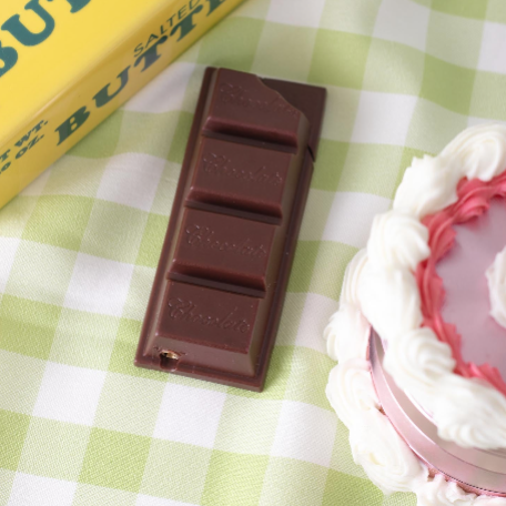 Chocolate Bar Lighter shown next to a candle holder and birthday cake.