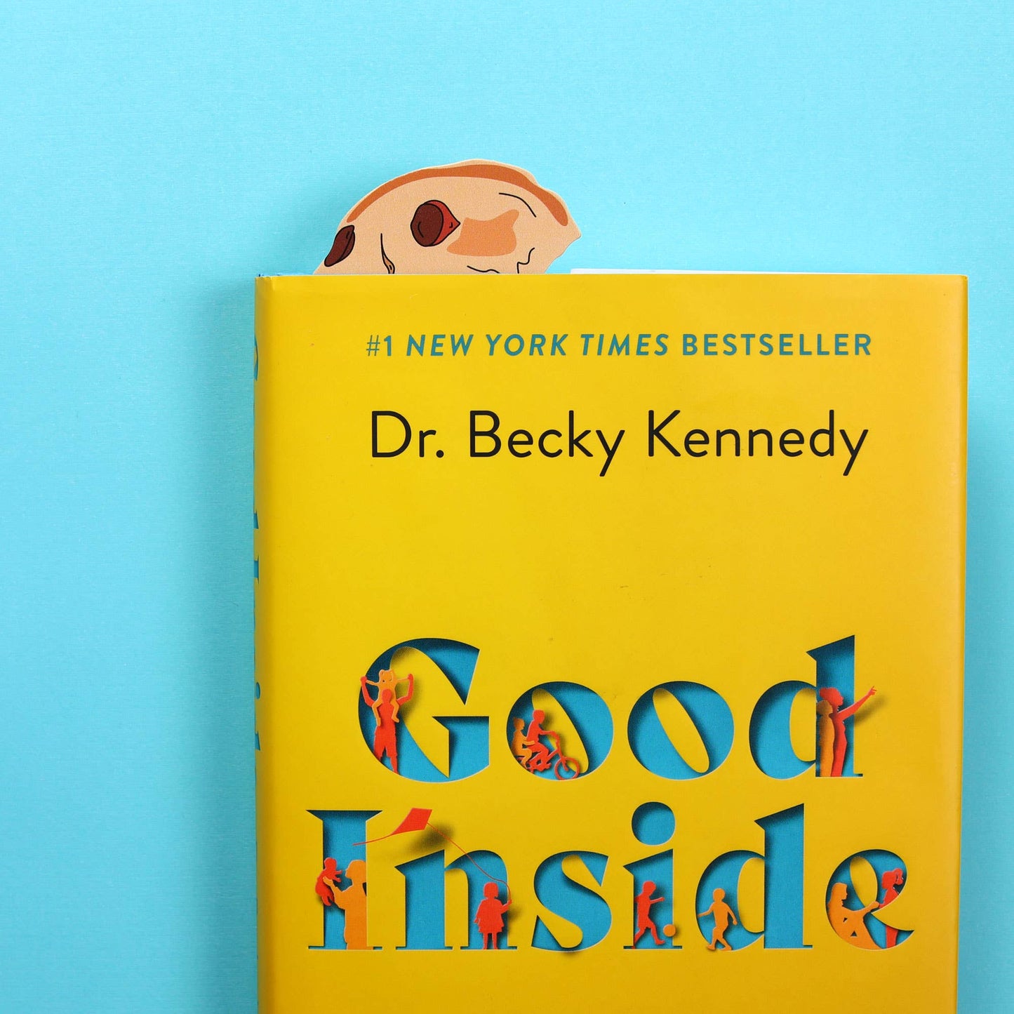 Chocolate chip cookie bookmark peeking out from a book
