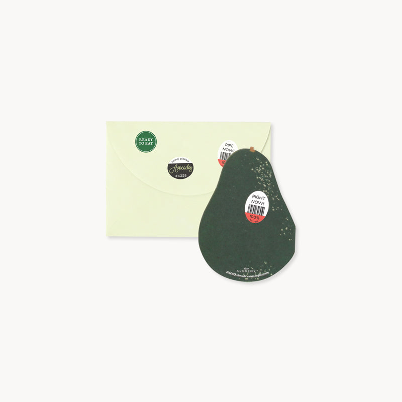 Picture of die-cut avocado greeting card with green envelope featuring faux grocery store stickers.