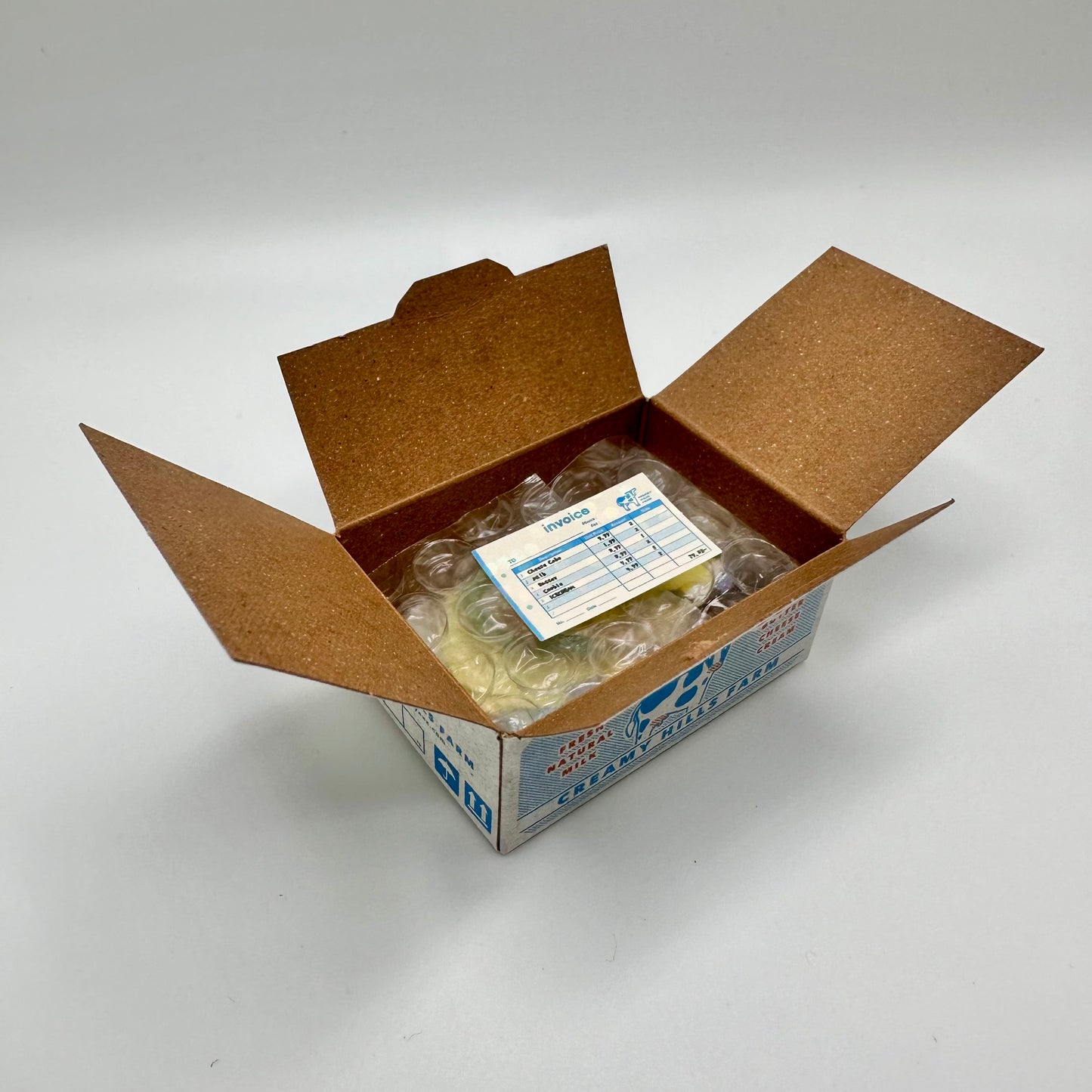 Box that is open to reveal a little sticker that looks like an invoice
