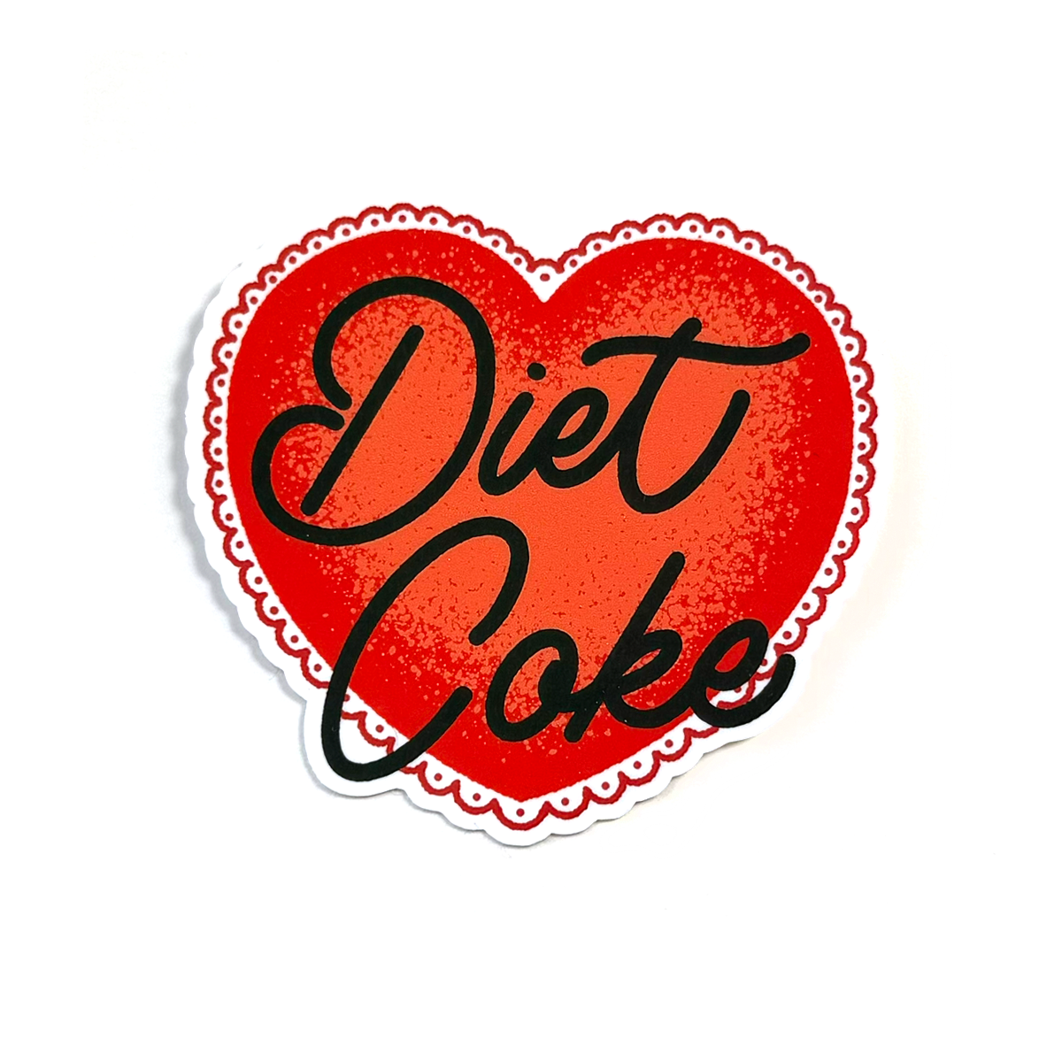A die-cut heart-shaped sticker with a red textured center, black cursive text reading 'Diet Coke,' and a white scalloped border on a white background.