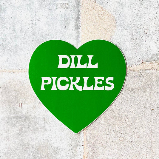 Green, heart shaped sticker with text in the middle that reads "Dill Pickles"