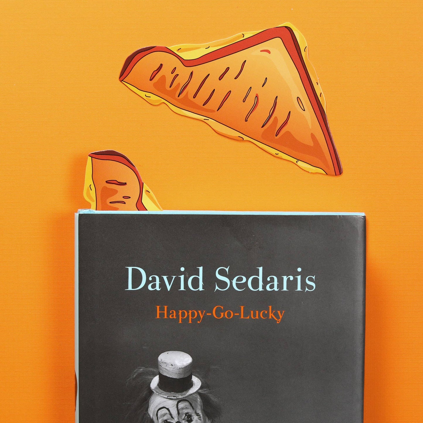 bookmark that looks like a triangle shaped half of a grilled cheese sandwich.