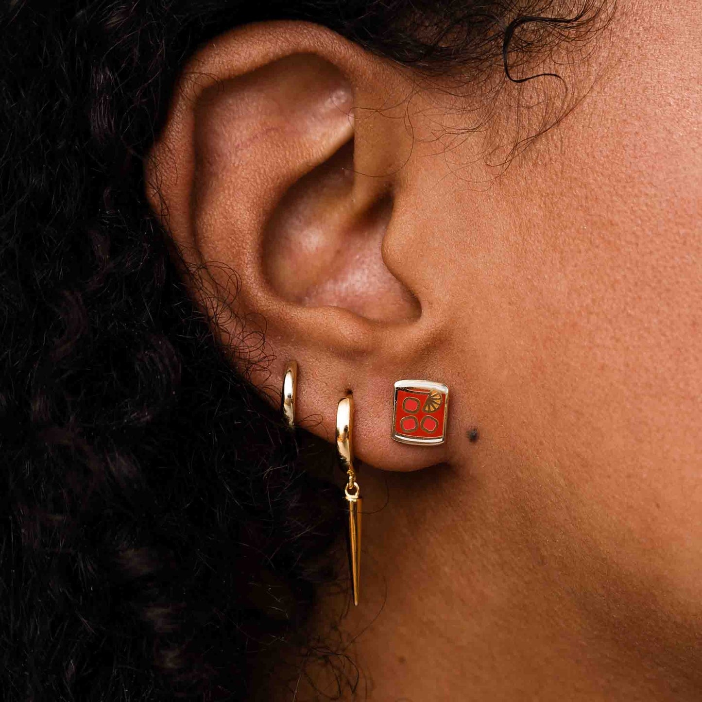 Negroni stud earring on ear lobe