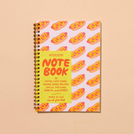 Notebook with neon hot dog pattern with a squiggle of mustard.