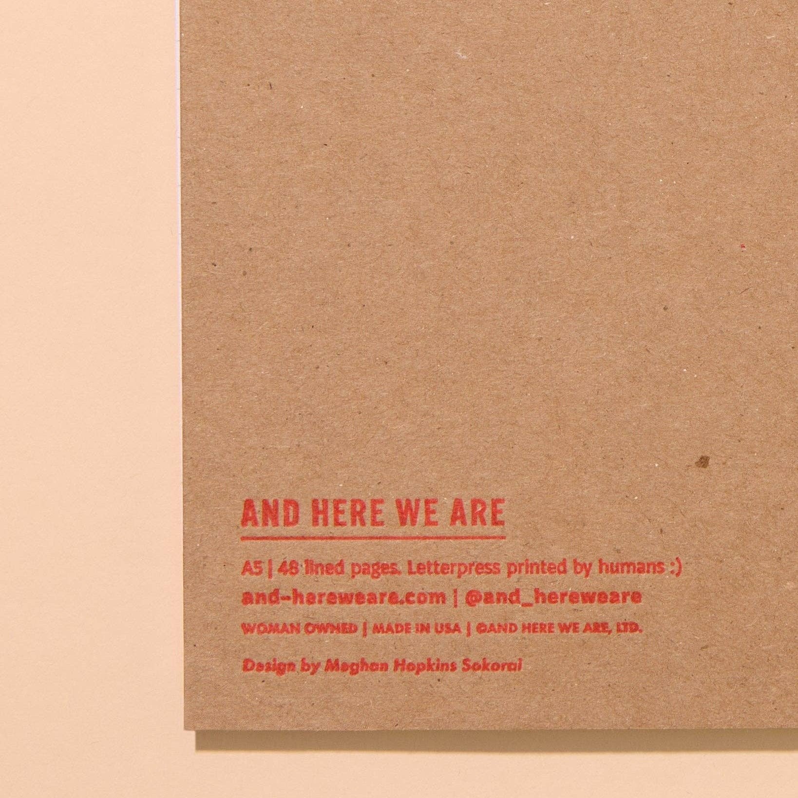 Back of notebook to show logo: And Here We Are