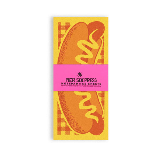 Notepad with hot dog illustration and 'Pier Six Press' branding on a yellow background