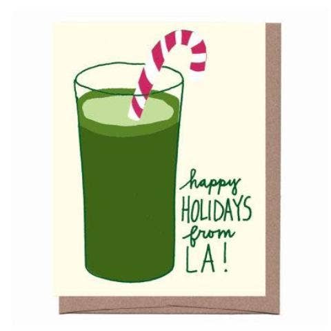 Card with a green drink and candy cane on a beige background, featuring 'happy holidays from LA!' text.