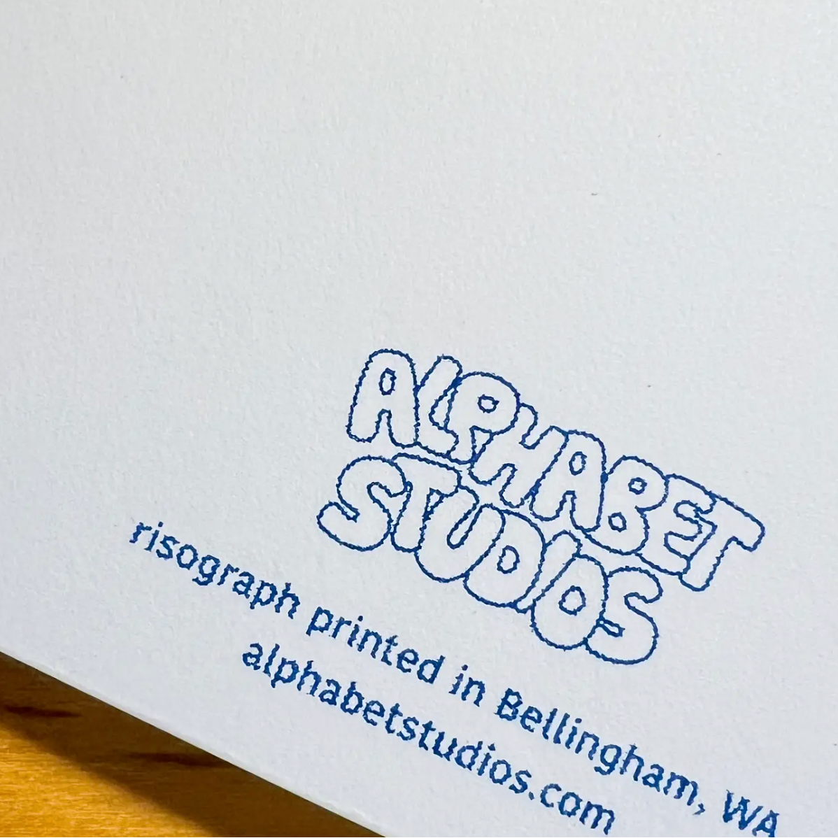 Letterpress printed text on a white background with 'Alphabet Studios' branding.