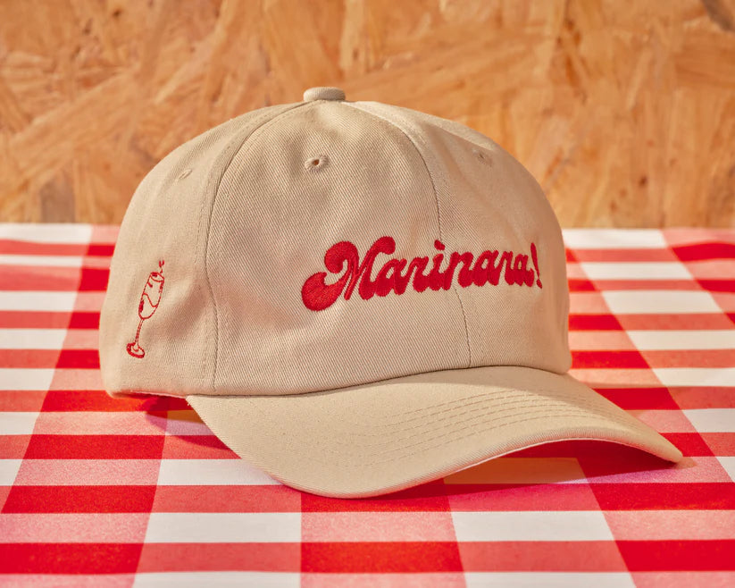 light colored cap with "Marinara!" embroidered in red on the front