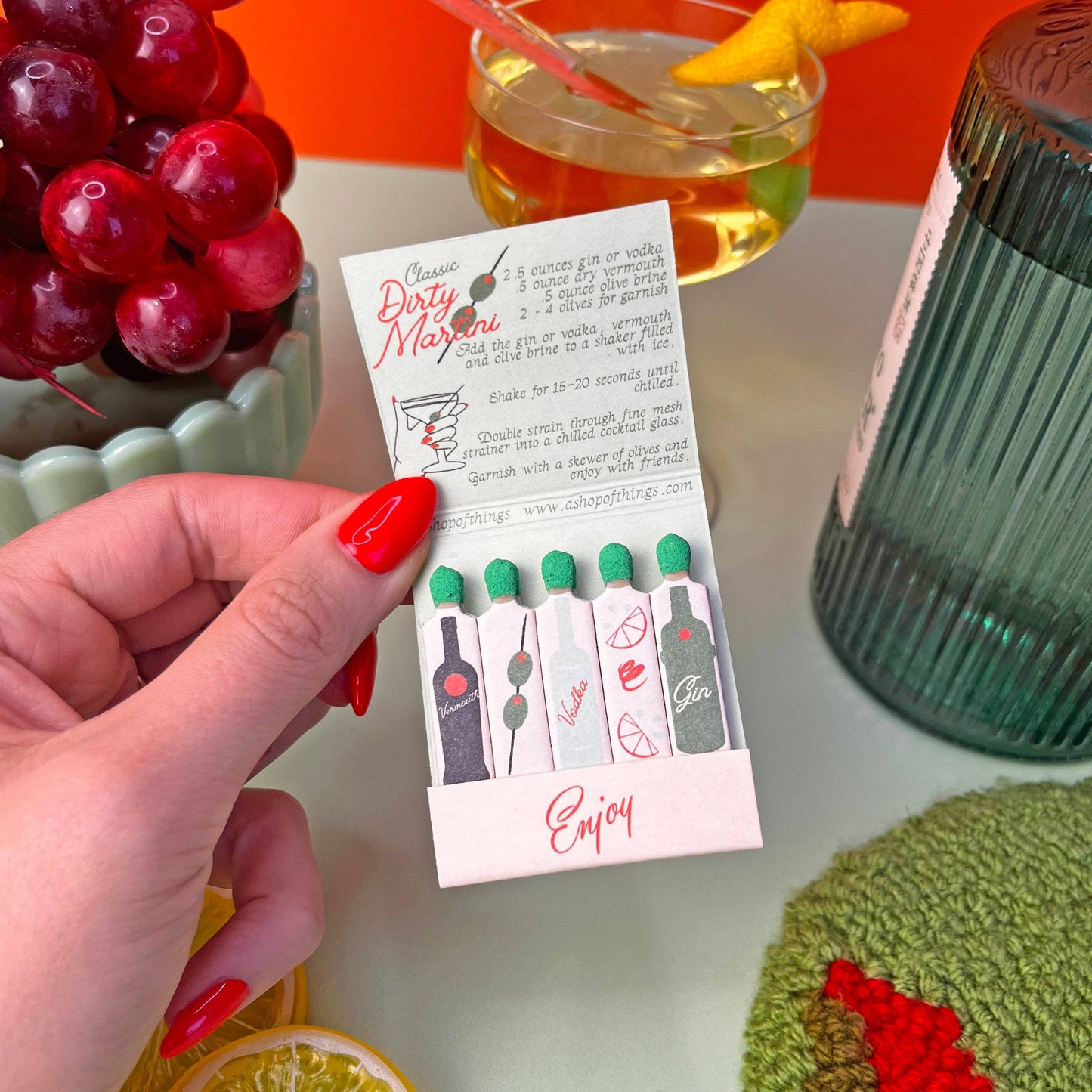 Matchbook in Dirty Martini theme. Each match is an ingredient in making this classic cocktail. Recipe is also written inside the matchbook. Book also says Enjoy.