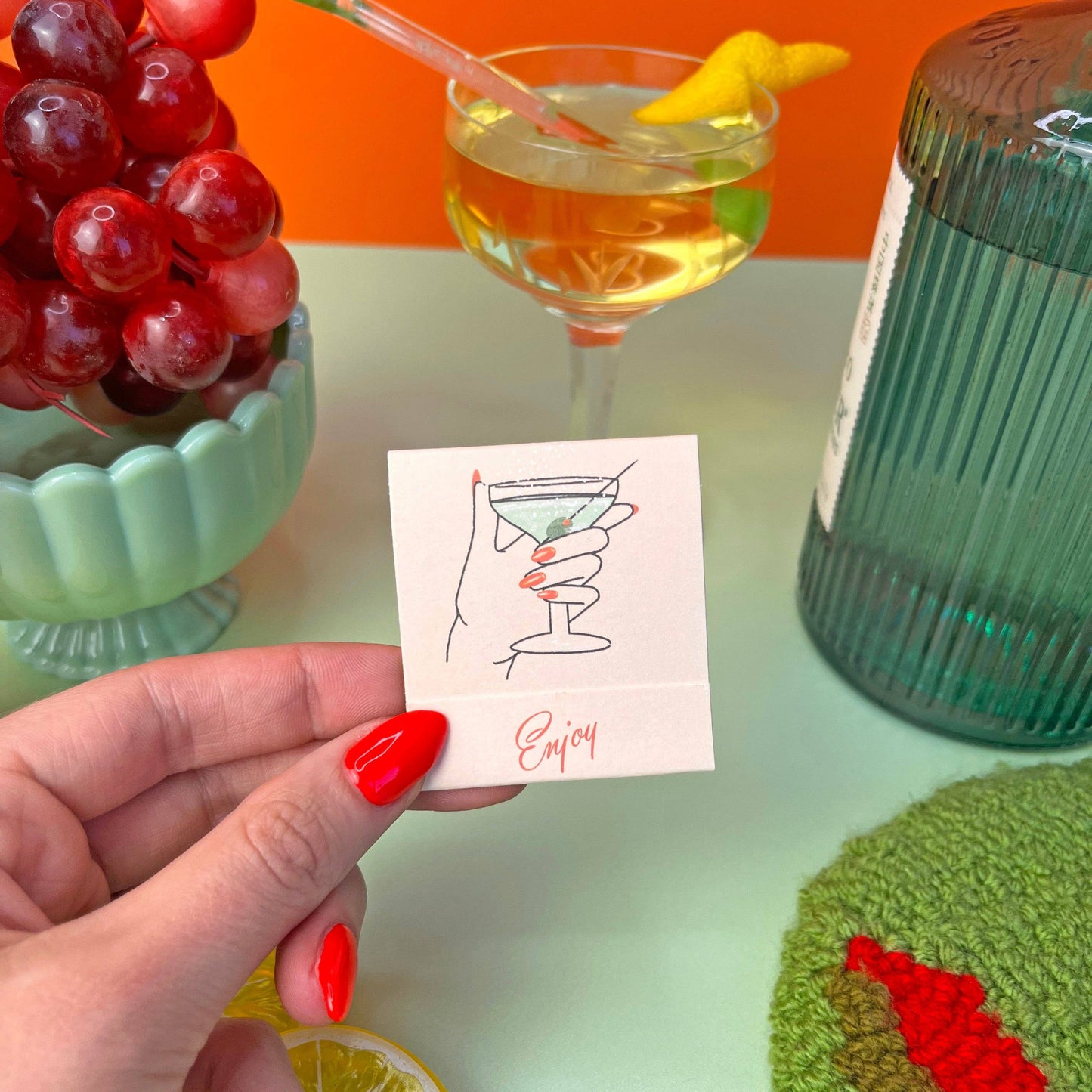 Matchbook in Dirty Martini theme. Each match is an ingredient in making this classic cocktail. Recipe is also written inside the matchbook. Book also says Enjoy.