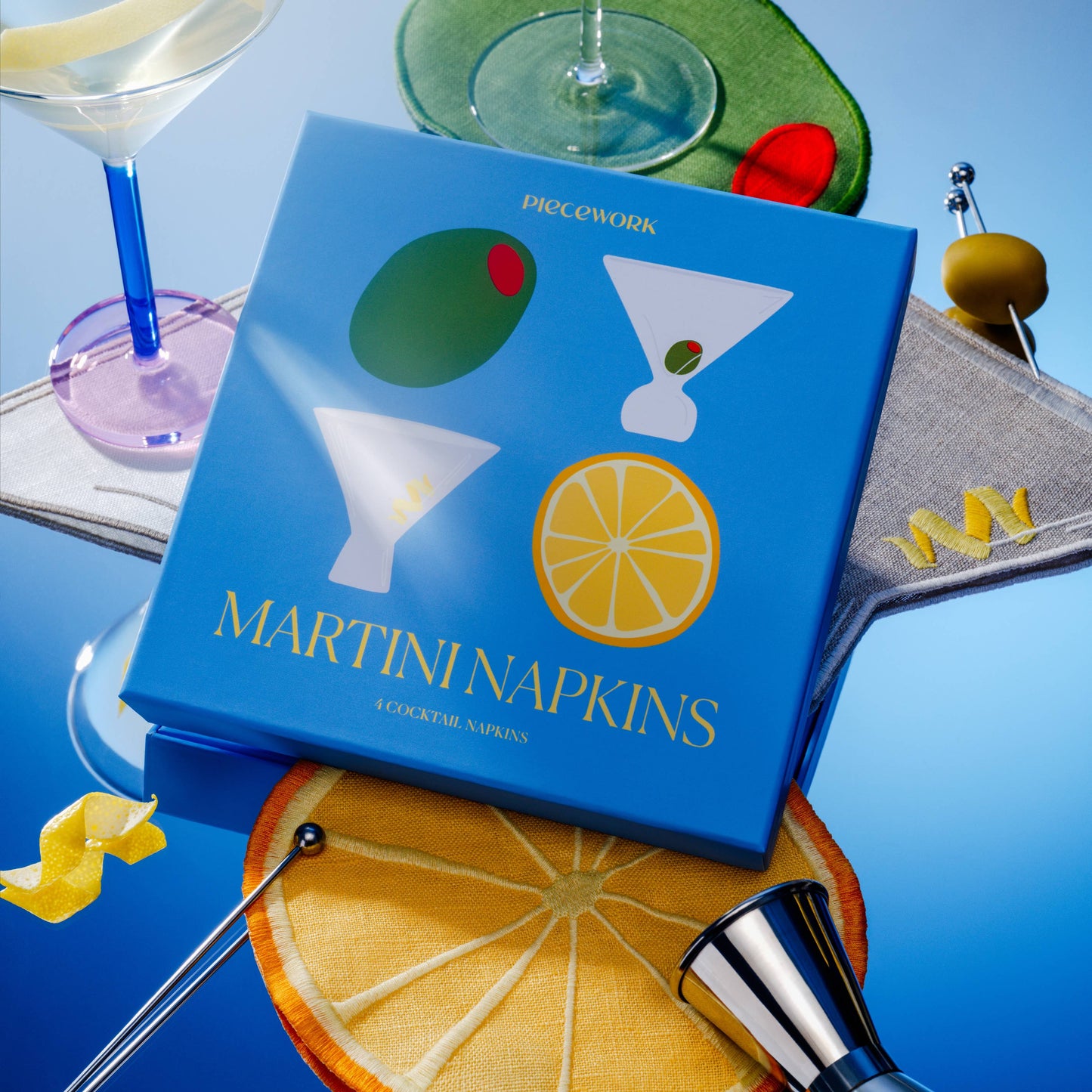 Blue box of Martini Napkins with cocktail-themed design on a blue background with bar accessories.