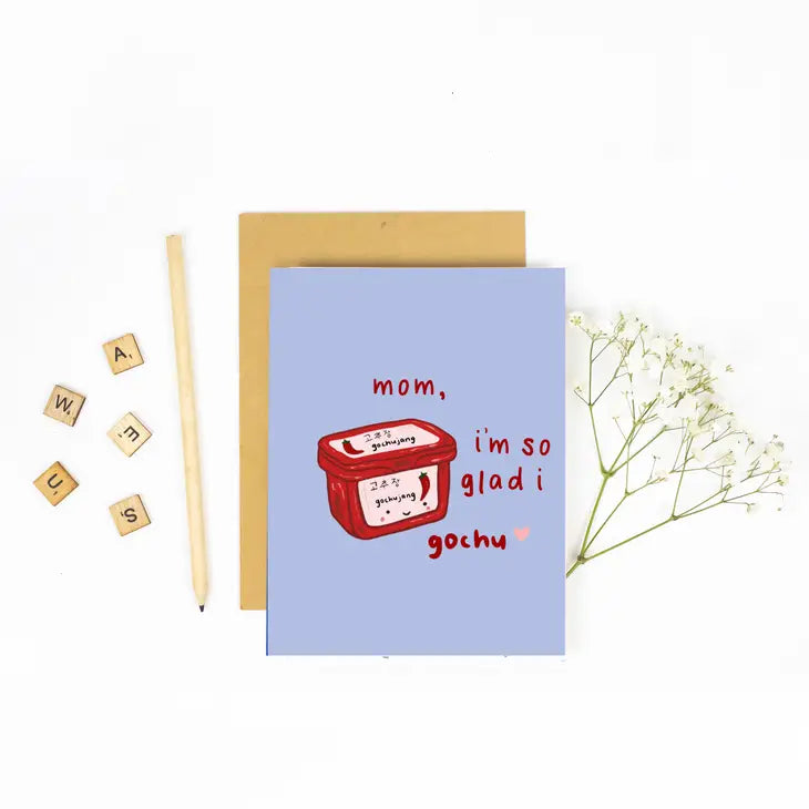 Blue greeting card with a tub of gochujang on it. Text reads "Mom, I'm so glad I gochu"