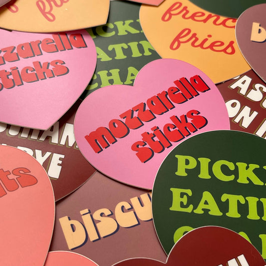 Colorful heart-shaped cutouts with text on a green background