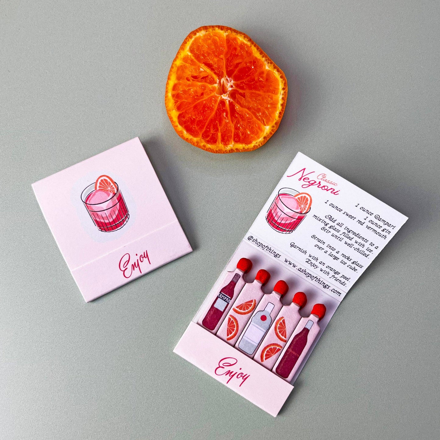 Image showcasing exterior and interior of negroni matchbook. Interior of flap has the recipe for a negroni cocktail