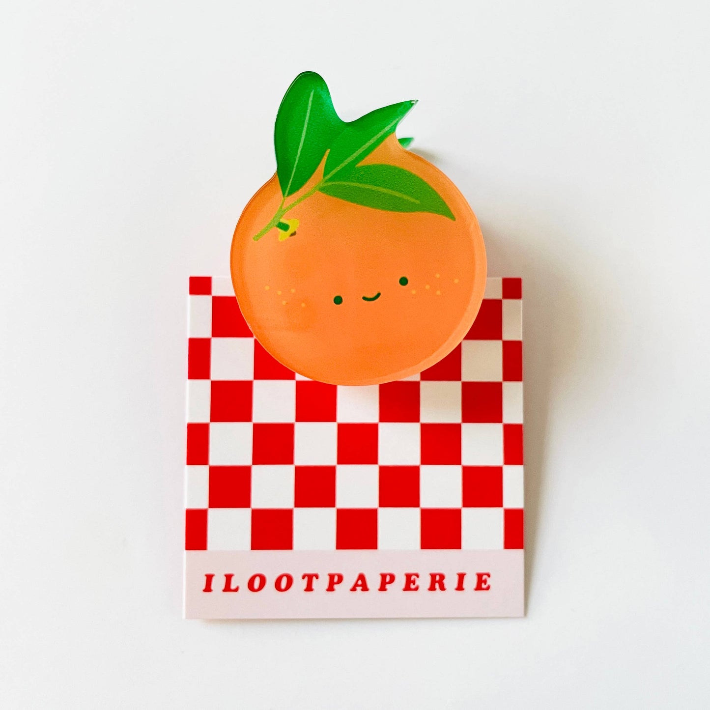 small acrylic clip that looks like an orange