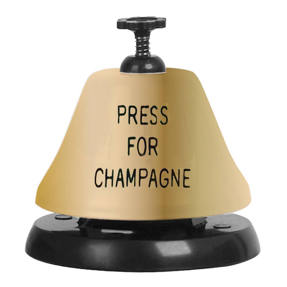 Decorative, gold bell with black text on it that reads "Press for Champagne"