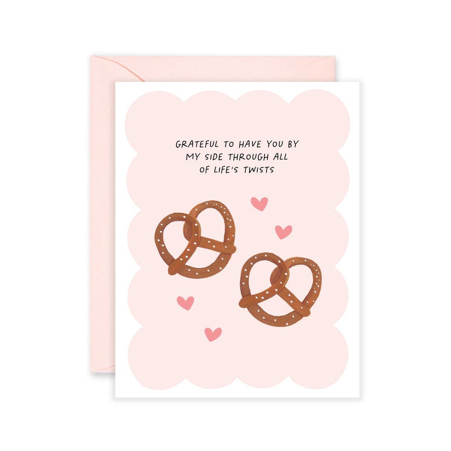 Pink greeting card with two pretzels and some hearts on it with text that reads "grateful to have you by my side through all of life's twists"