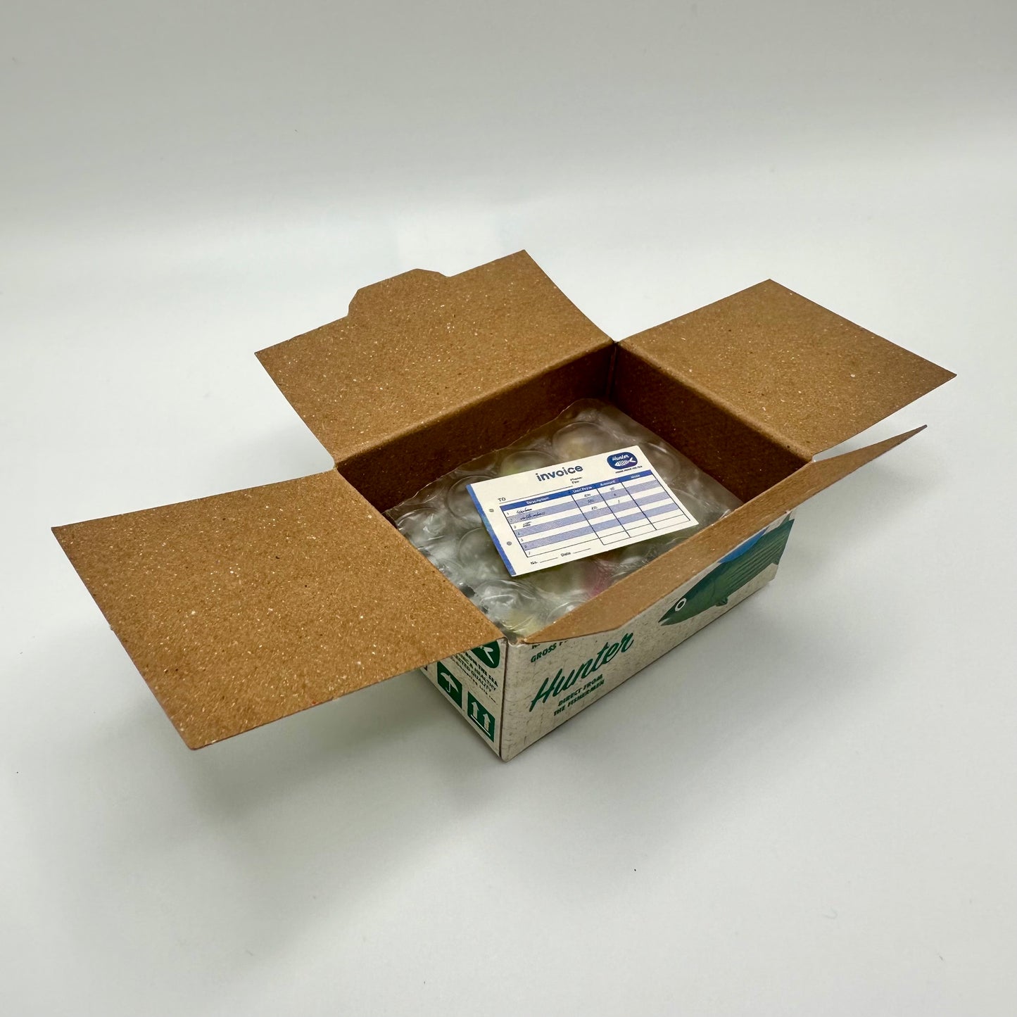 Sticker box open to reveal a tiny invoice that is actually a sticker.