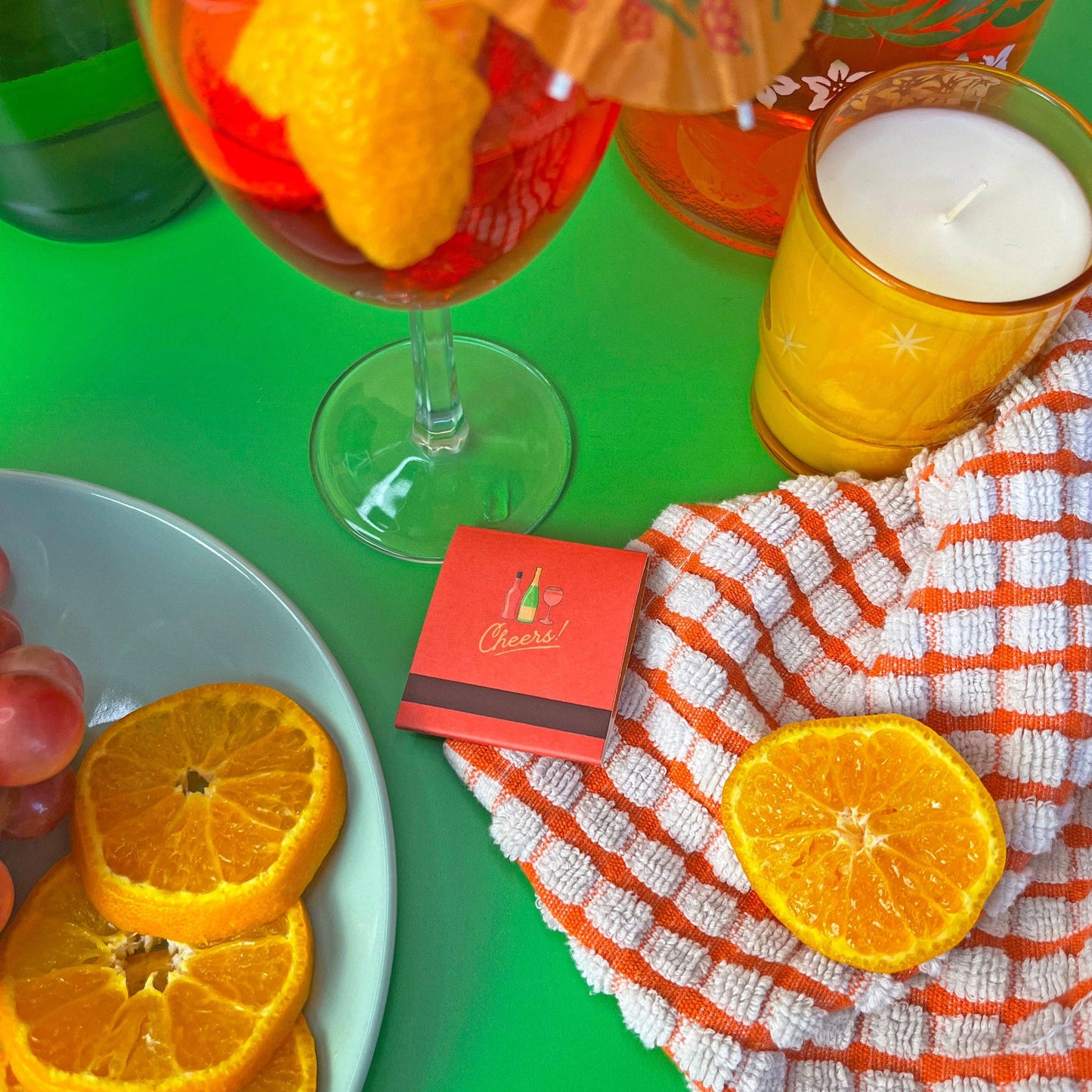 Negroni matchbook. Each match has a different ingredient on each match. Inside the matchbook is a recipe of how to make a spritz. The matchbook says Enjoy