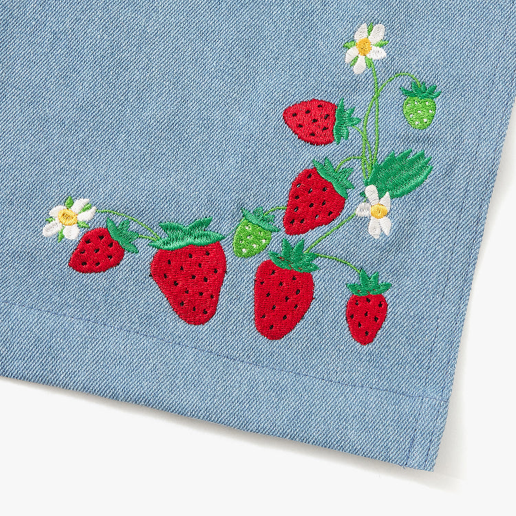 Blue apron with red straps. This apron is dedicated to strawberries with embroidery of strawberries in a basket and on a vine with little white flowers.