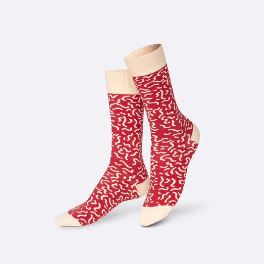 Red patterned socks with beige accents on a white background