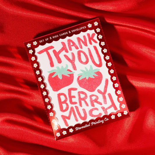 box set of strawberry themed thank you cards pictured on red background