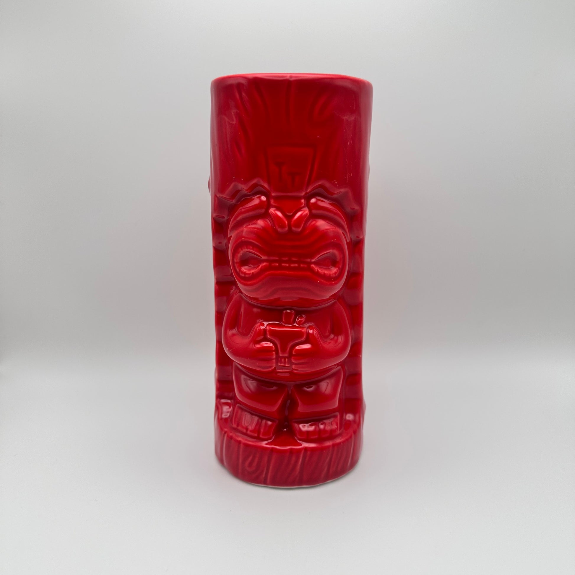 Red tiki mug with a face on a white background