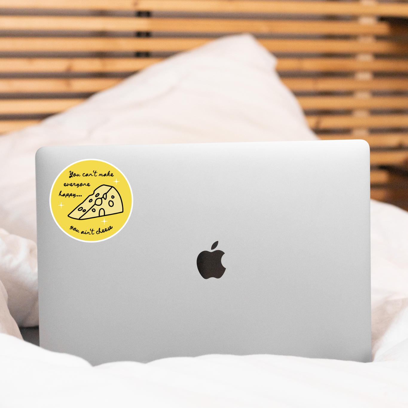 Laptop with a sticker on a bed
