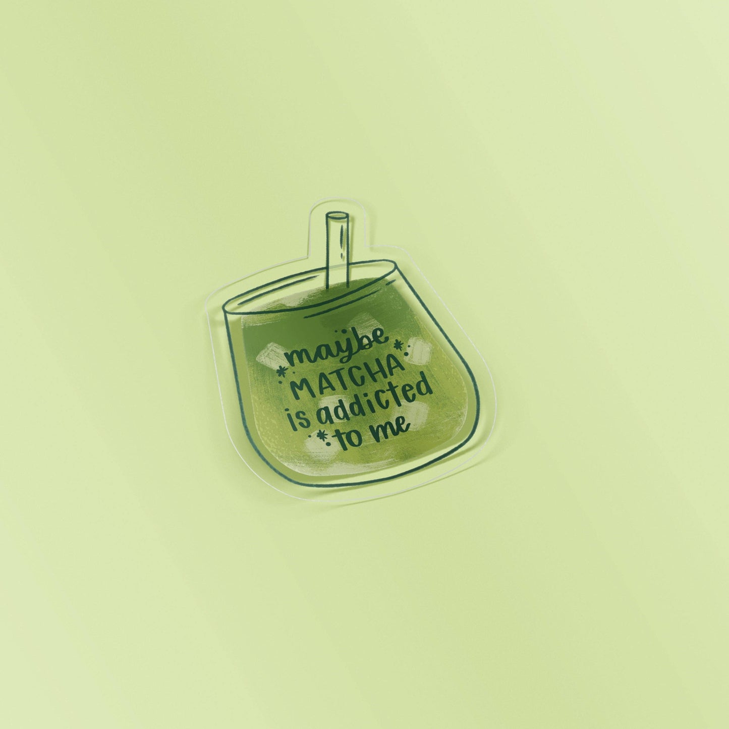 Sticker with a cup of matcha and text 'maybe MATCHA is addicted to me' on a light green background
