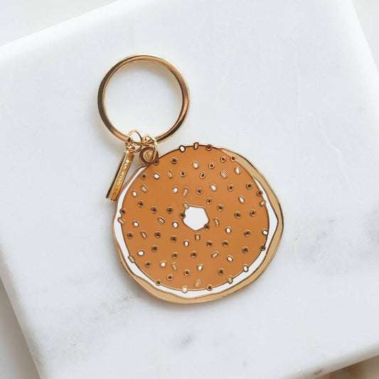 bagel enamel keychain -- has seasoning detailing along with a thin layer of schmear