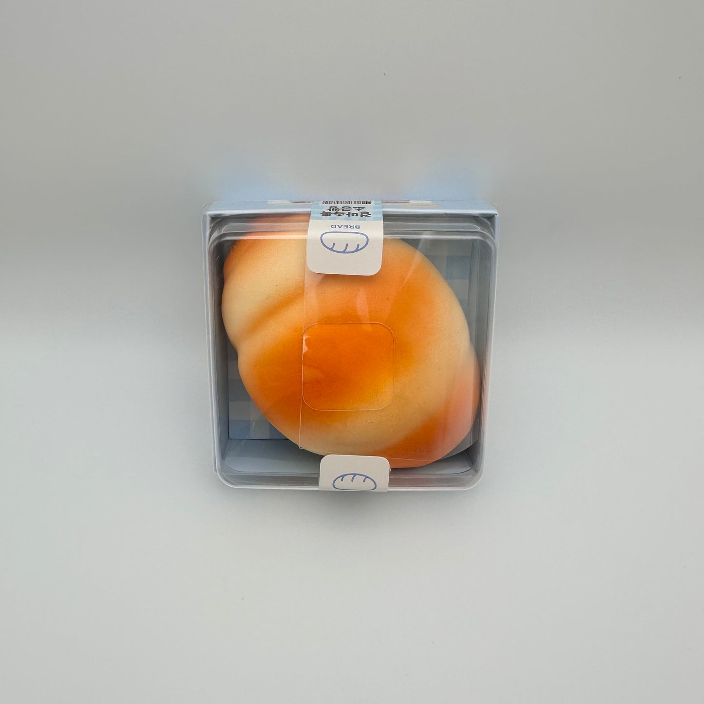 Stress ball that looks like a Japanese salt bread and comes in boxed packaging