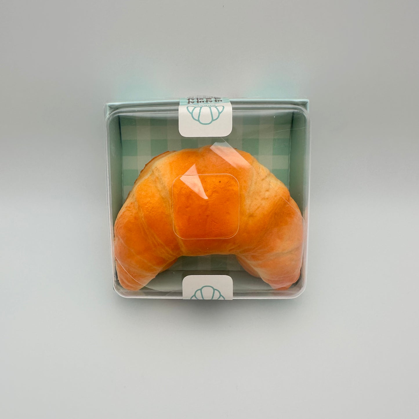 Packaged stress ball that looks like a croissant