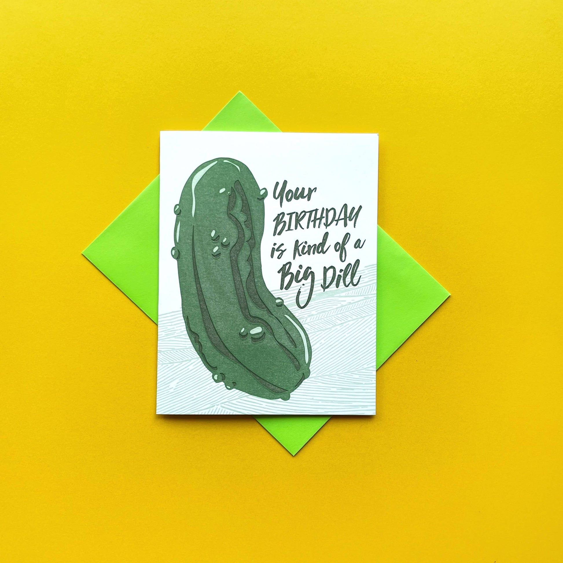 Greeting card with a large dill pickle on it with text that reads "Your birthday is kind of a big dill"